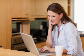 Grey market_woman shopping on laptop stock picture